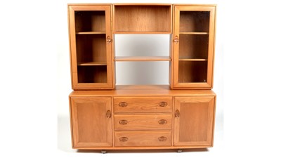 Lot 354 - Ercol: an elm Windsor sideboard and display cabinet.