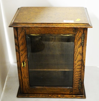 Lot 321 - An oak smokers cabinet.