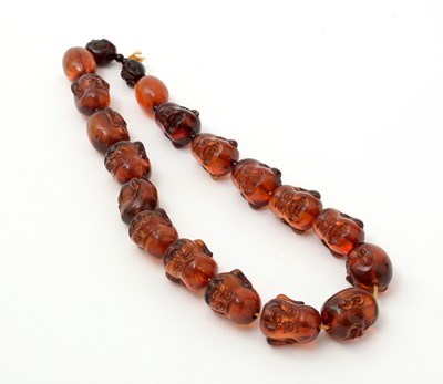 Lot 668 - Amber Buddha head bead necklace
