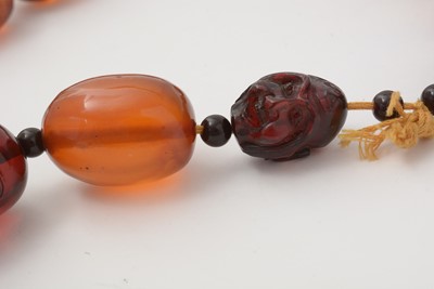 Lot 668 - Amber Buddha head bead necklace