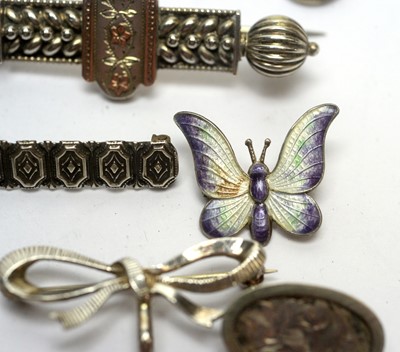Lot 129 - A selection of silver and other brooches