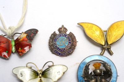 Lot 134 - A selection of silver and enamel brooches, and others