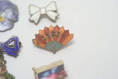 Lot 134 - A selection of silver and enamel brooches, and others