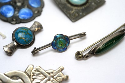 Lot 105 - A selection of Arts and Crafts and other brooches and button.