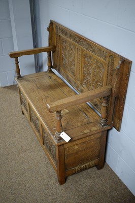 Lot 9 - An early 20th Century carved oak monk's bench.