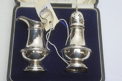 Lot 169 - Silver jug and caster set and another caster.