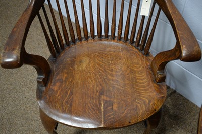 Lot 19 - A pair of early 20th Century oak bow-back smokers chairs.