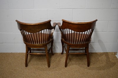 Lot 19 - A pair of early 20th Century oak bow-back smokers chairs.