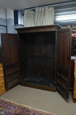 Lot 66 - A profusely carved oak wardrobe, basically Georgian with later Victorian carving.