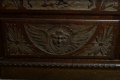 Lot 66 - A profusely carved oak wardrobe, basically Georgian with later Victorian carving.