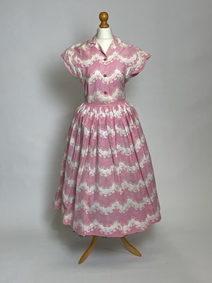 Lot 829 - A late 1940s Horrockses printed cotton day dress | in a stylised scalloped lace pattern on pink
