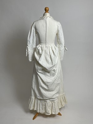 Lot 842 - A late 1960s Laura Ashley "Victorian Revival" ivory seersucker bustle dress