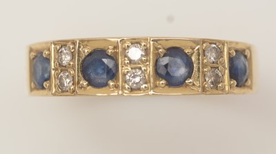 Lot 478 - A sapphire and diamond half-hoop eternity ring