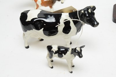 Lot 361 - A collection of Beswick and other ceramic cow figures.