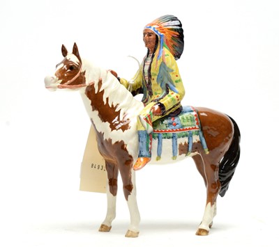 Lot 351 - A Beswick figure of a Native American on Skewbald Horse.