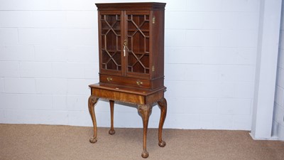 Lot 43 - A Georgian-style mahogany cabinet on stand.