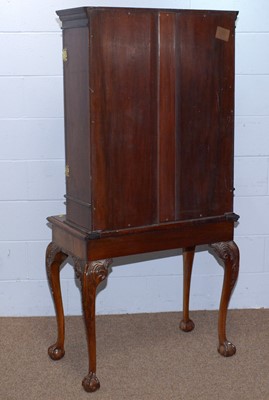 Lot 43 - A Georgian-style mahogany cabinet on stand.