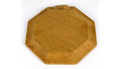 Lot 1266 - Workshop of Robert ‘Mouseman’ Thompson (Kilburn): an oak chopping board/teapot stand.