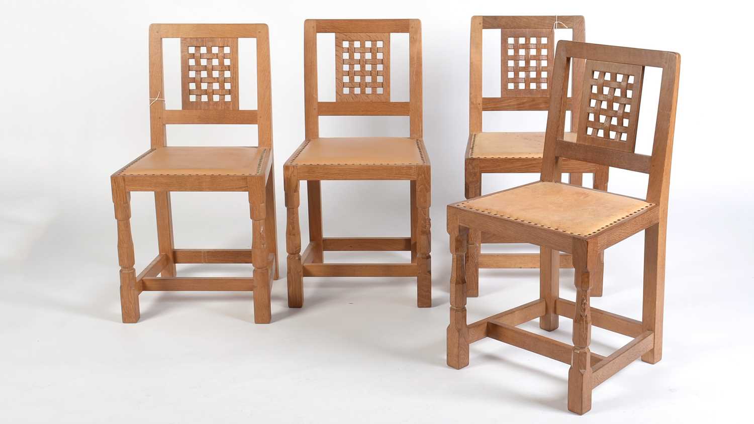 Lot 1282 - Workshop of Robert ‘Mouseman’ Thompson (Kilburn): four oak lattice back chairs.