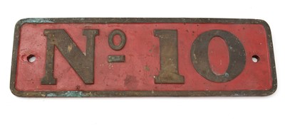 Lot 763 - A cast bronze and red painted engine plate