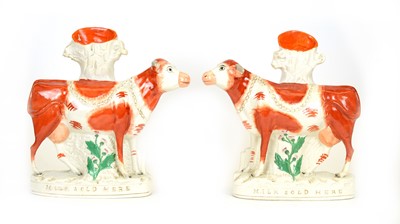 Lot 701 - Pair of Staffordshire 'MILK SOLD HERE' cows