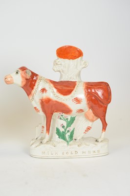 Lot 701 - Pair of Staffordshire 'MILK SOLD HERE' cows