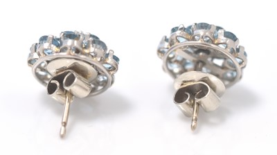 Lot 493 - A pair of diamond and blue topaz cluster earrings