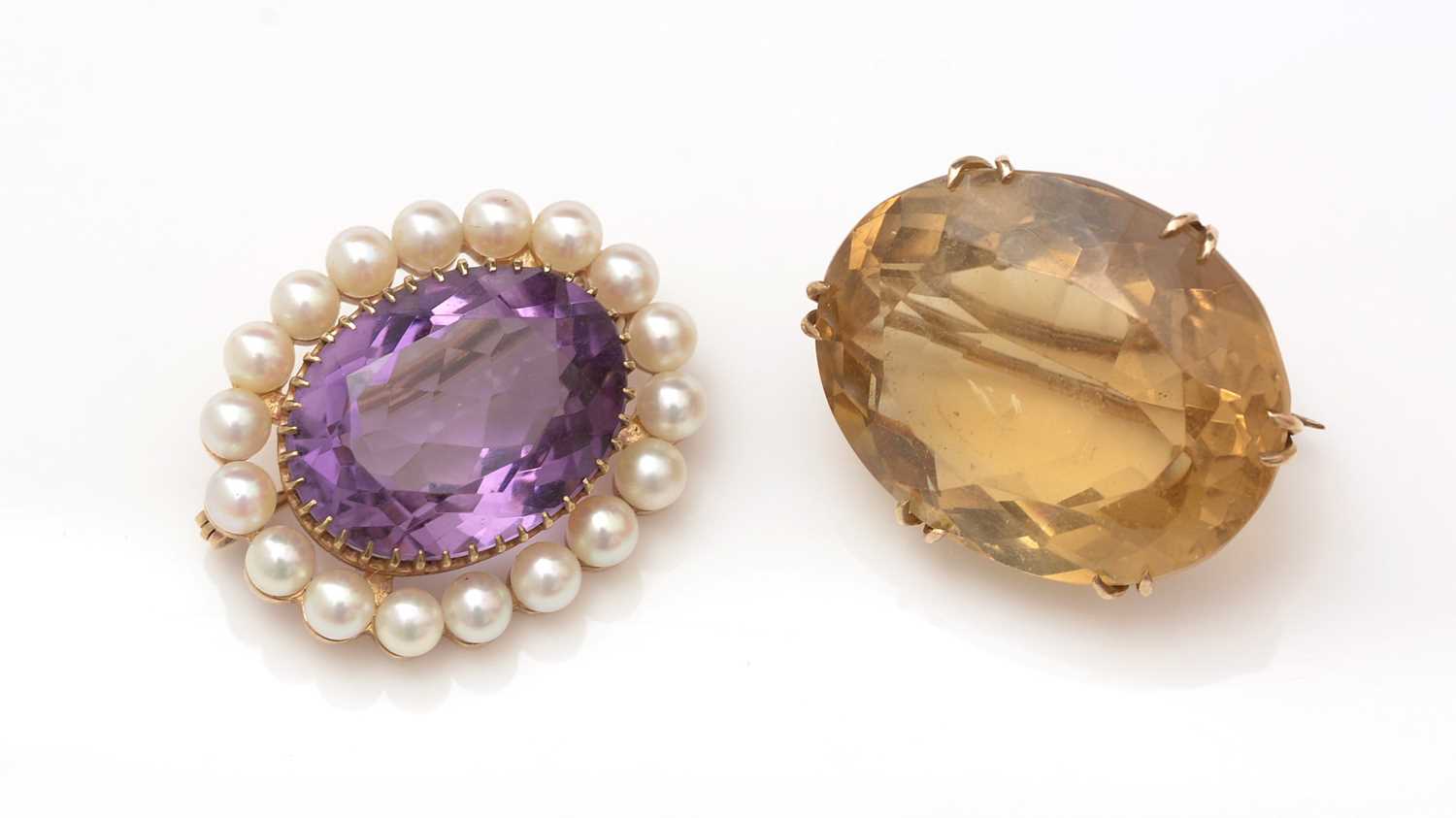 Lot 401 - A citrine brooch and an amethyst and cultured pearl brooch.
