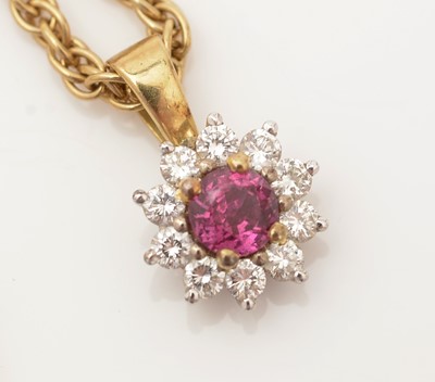 Lot 334 - A ruby and diamond cluster pendant