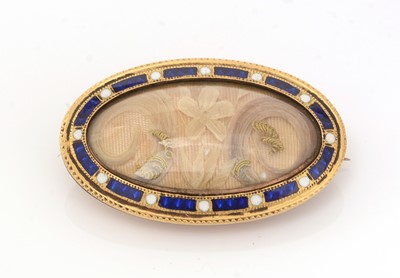 Lot 498 - A Victorian hair-work and enamel mourning brooch