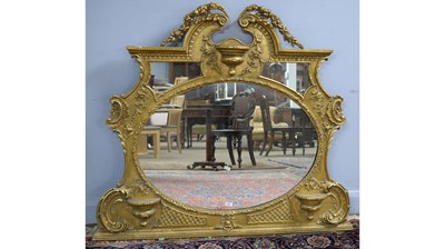 Lot 103 - An ornate late 19th Century gold painted overmantel mirror.