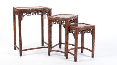 Lot 1318 - A nest of three Chinese carved huanghuali occasional tables