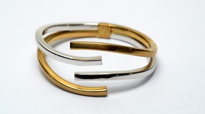 Lot 218 - A 9ct yellow and white gold bangle
