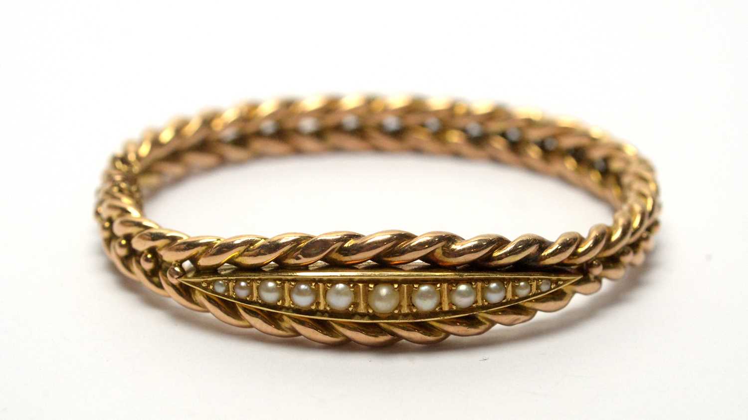 Lot 143 - A late Victorian 14ct yellow gold and graduated half pearl bangle