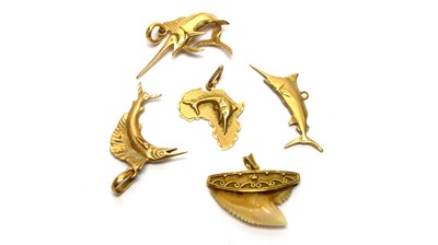 Lot 160 - Four 18ct yellow gold swordfish pattern pendants, and a sharks tooth pendant