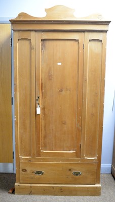 Lot 91 - An early 20th Century stripped pine single-door wardrobe.