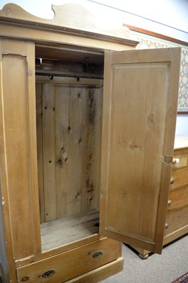 Lot 91 - An early 20th Century stripped pine single-door wardrobe.