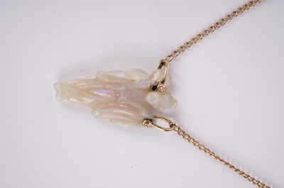 Lot 1160 - A Chinese carved opal pendant