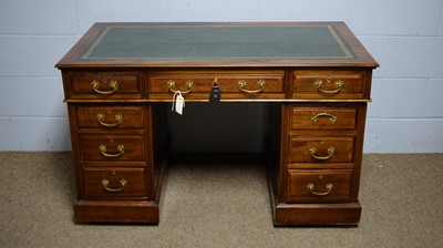 Lot 38 - An Edwardian mahogany twin-pedestal writing desk.