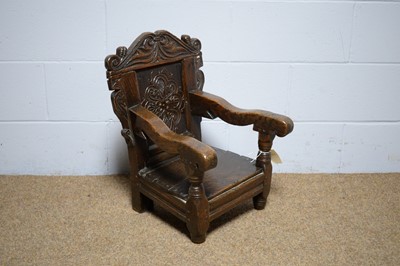 Lot 4 - A carved oak child’s chair.