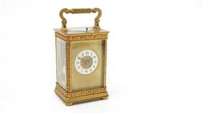 Lot 1039 - An ornate late 19th Century French gilt brass repeating carriage clock.