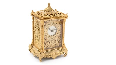 Lot 1037 - An ornate French gilt metal carriage clock.