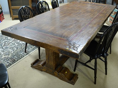 Lot 71 - A substantial Jacobean style carved oak refectory dining table..