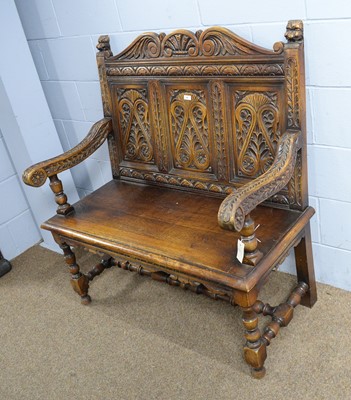 Lot 44 - N.H. Chapman & Co. Ltd. of Newcastle: a Jacobean-style carved oak hall seat.
