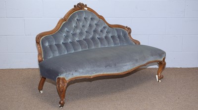 Lot 46 - A Victorian carved walnut button back settee.