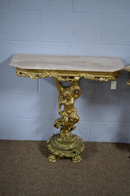 Lot 43 - Two gold-painted and onyx cherub pattern corner/side tables.