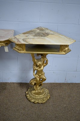 Lot 43 - Two gold-painted and onyx cherub pattern corner/side tables.