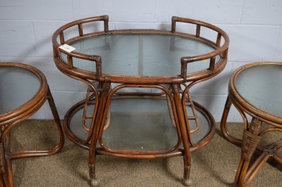 Lot 65 - Oval bamboo two-tier trolley; and a pair of circular occasional tables.