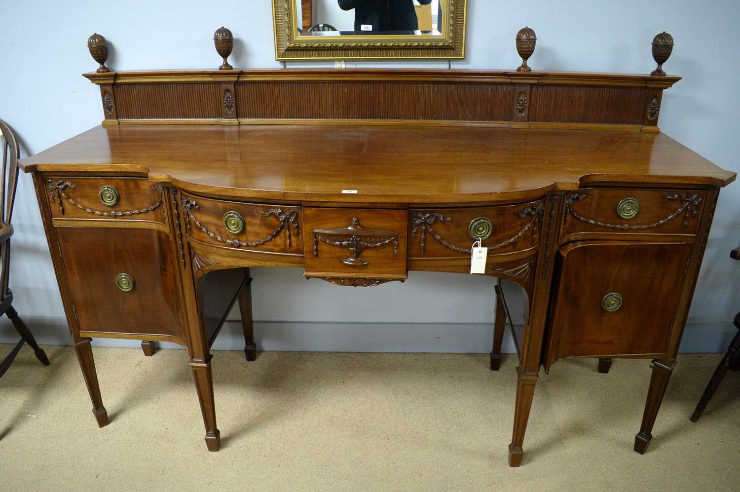 Lot 100 - Warings: an impressive fine quality Adam style mahogany bowfront sideboard.