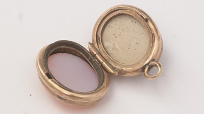 Lot 130 - Two rings, a locket and a pendant.
